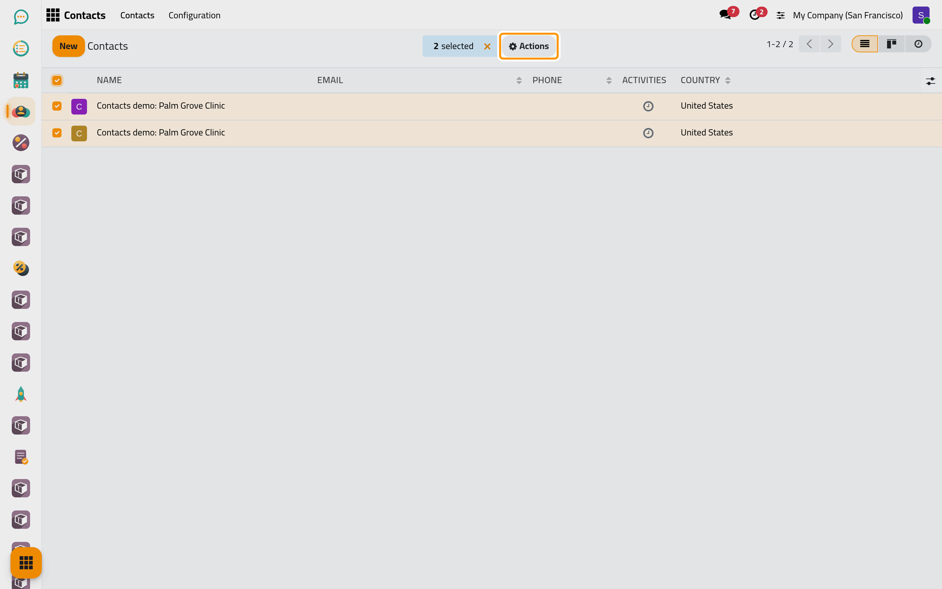 The two records of the same clinic, both ticked; Actions now offers Merge.